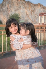 Fototapeta premium Two asian little child girls hugging 