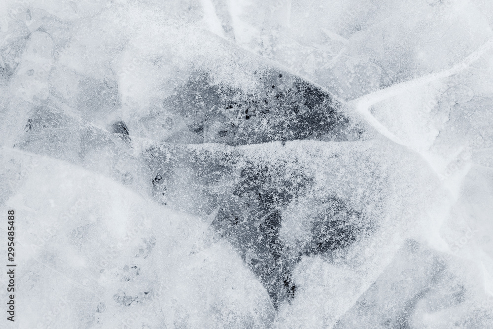 Poster close-up of snow on cracked and thin layers of ice in the winter. simple and minimal full frame abst