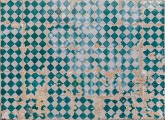 Close-up of an old, weathered and cracked wall with colorful ceramic tiles (azulejos) in Lisbon, Portugal. High resolution full frame textured background.