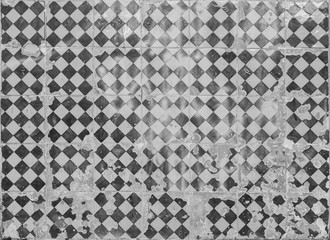 Close-up of an old, weathered and cracked wall with ceramic tiles (azulejos) in Lisbon, Portugal. High resolution full frame textured background in black and white.