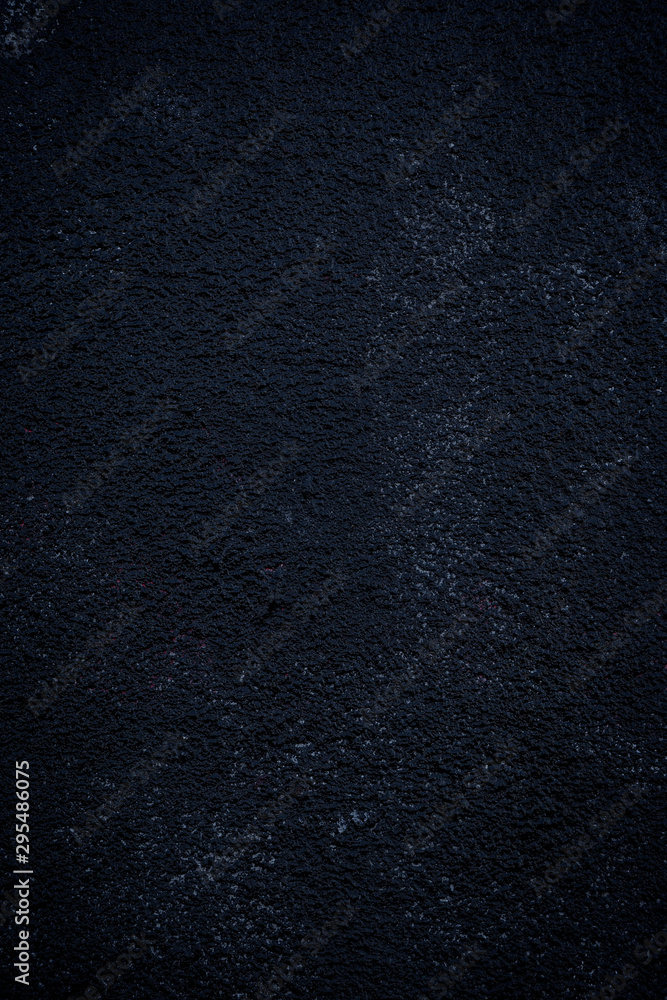 Poster close-up of a plastered and rough wall painted in black. high resolution full frame textured backgro