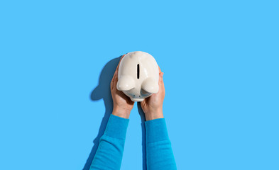 Person holding a piggy bank from above