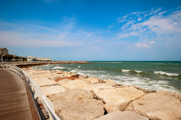 Fototapeta na wymiar Pesaro, Adriatic coast. Pier and seafront in Pesaro,