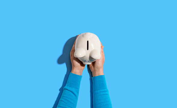 Person Holding A Piggy Bank From Above