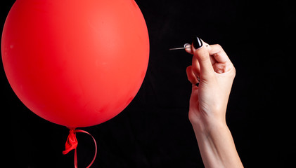 burst red balloon with a needle - danger concept © fidelio