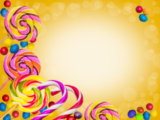 Colorful frame of sweets and lollipops on a bright background.