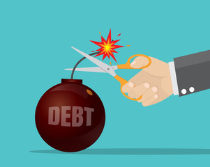 businessman's hand holding scissors to cut debt bomb.