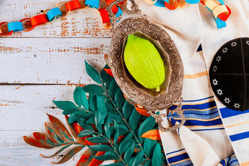 Traditional symbols Jewish festival of Sukkot Etrog, lulav, hadas, arava praying book kippah Tallit