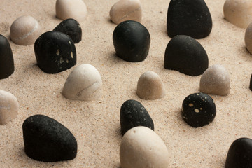 Fototapeta na wymiar Rock garden. Stones sticking out of the sand in the sunlight.