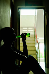 Silhouette of drunken man drinking beer are having stress in life and unable to find a solution and...