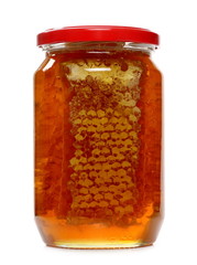 Jar of honey with honeycomb isolated on white background