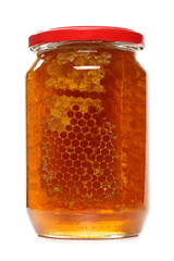 Jar of honey with honeycomb isolated on white background