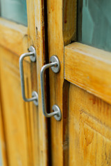 metal handle on a brown wooden door. black wicker handle on the old door.