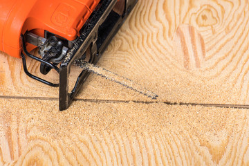 jigsaw saw a sheet of plywood or wood, prongs close-up macro