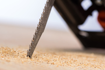 jigsaw saw a sheet of plywood or wood, prongs close-up macro