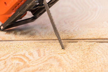jigsaw saw a sheet of plywood or wood, prongs close-up macro