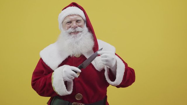 Santa Claus holding a knife. Evil Santa Claus concept. Murder.