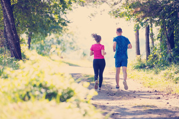 Fototapeta na wymiar young couple jogging on sunny day at nature