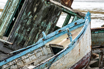 The Noirmoutier boats cemetery. Close-up of the wrecks of old fishing boats piled on top of one...