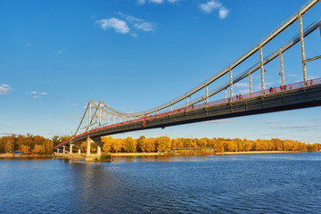 Pedestrian bridge across the Dnieper River, autumn landscape, Kiev