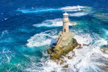 Rolgordijnen The beautiful Lighthouse Tourlitis of Chora in Andros island and a seagull, Cyclades, Greece © Aleh Varanishcha