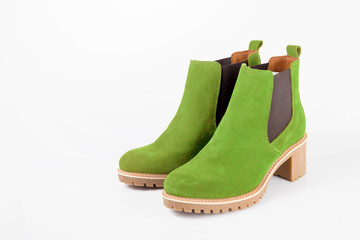 Female green leather boots on white background, isolated product.