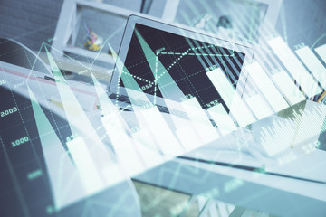 Forex Chart hologram on table with computer background. Multi exposure. Concept of financial markets.