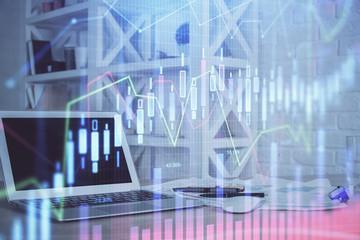 Stock market graph on background with desk and personal computer. Double exposure. Concept of financial analysis.