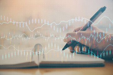 Forex graph on hand taking notes background. Concept of research. Multi exposure
