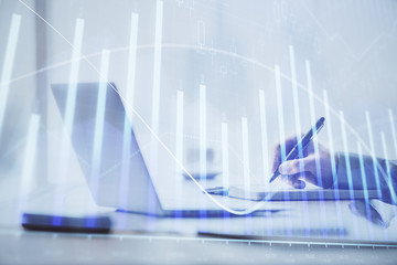 Multi exposure of forex chart with man working on computer on background. Concept of market...