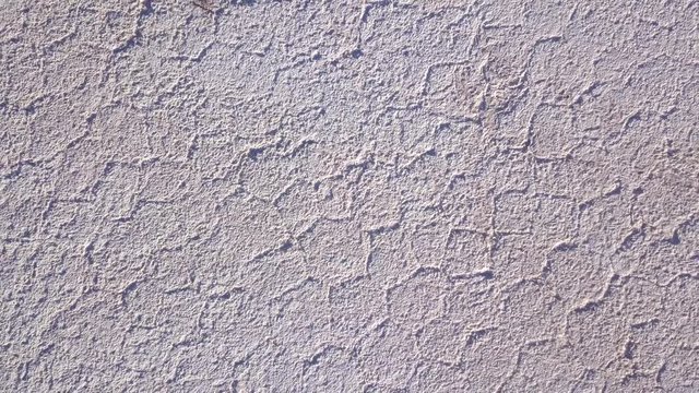 Aerial rising over hexagonal salt patterns in Uyuni salt flat terrain. TOP DOWN