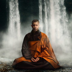 Buddhist monk in lotus position. - obrazy, fototapety, plakaty