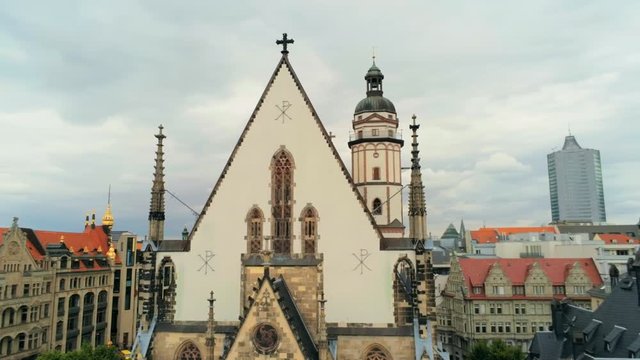 Aerial View of Scenic Landmark - St. Thomas Church (Thomaskirche) in Leipzig, Germany, Europe. Remains of Johann Sebastian Bach are there. 4K Background Long Orbit Shot