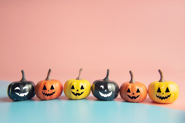 Halloween concept, Pumpkin with smile face on pastel colors background.