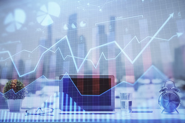 Forex Chart hologram on table with computer background. Double exposure. Concept of financial markets.