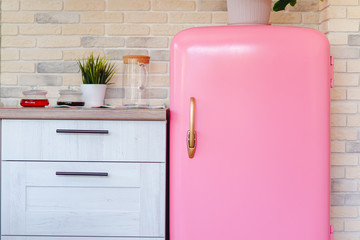 Retro style pink fridge in vintage kitchen