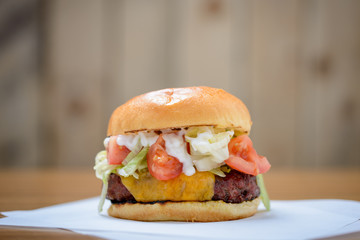 Beef burger with cheese and salad in brioche bun