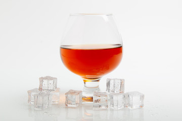 whiskey in glass and ice cube on a white background