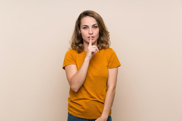 Young blonde girl over isolated background showing a sign of silence gesture putting finger in mouth
