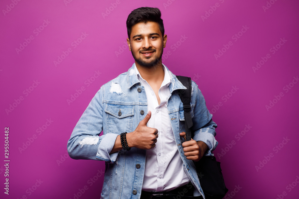 Wall mural portrait of handsome indian guy, okay sign, standing on violet background, copy space at side.