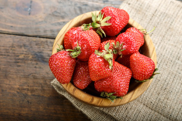 ripe strawberries on a wooden background