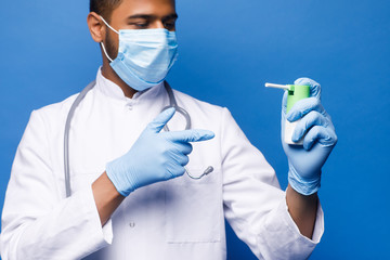 Medical laboratory time. Selective focus of blood sample being held by a nice handsome male scientist while sitting in the blue background.