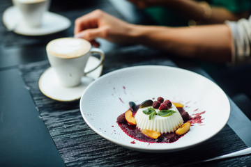 Close up view of beautiful elegant sweet dessert served on the plate. Beautiful decoration, restaurant dish, ready to eat. Tea time, cozy atmosphere.
