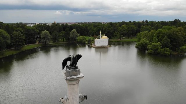 aerial view to Chesme Column with birds ravens on big eagle in a park of Catherine Palace (Yekaterininskiy dvorets)  in Tsarskoye Selo (Pushkin) with Turkish Bath in Catherine Park on the bath. 