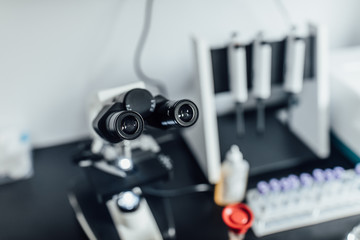 Powerful scientific laboratory microscope with multiple lenses. Biotechnology hardware equipment, white clinic. Instruments concept. Blood test,dispenser.