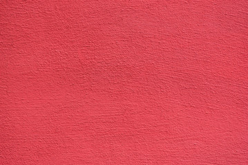 Bright rough plastered surface. Living coral colored. Backgrounds and textures