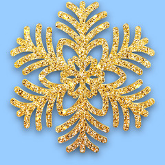 Golden luster textured six-rayed snowflake with a shadow on blue background. Christmas and for 2020 New Year design. Snow flake Shining particles decor for greeting card, poster or invitation © Iricat