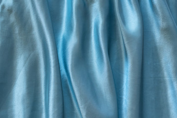Blue silk crumpled fabric. Texture background