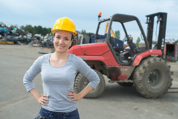 portrait of happy woman next to a tractor