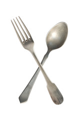 Crossed vintage spoon and fork isolated on bell background. Rustic style.